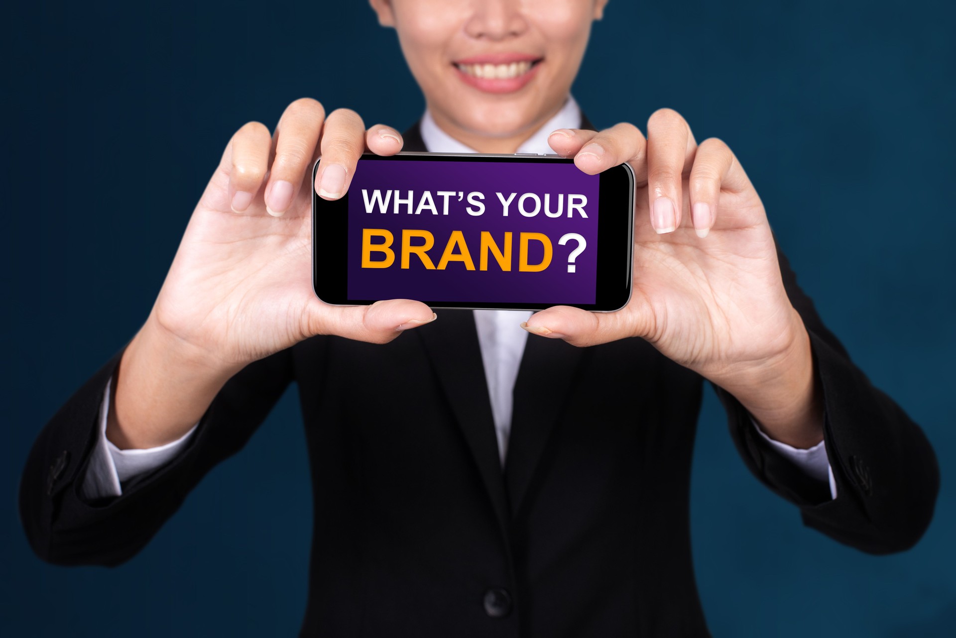 What's Your Brand?, Happy businesswoman Show text What's Your Brand? on smart phone.